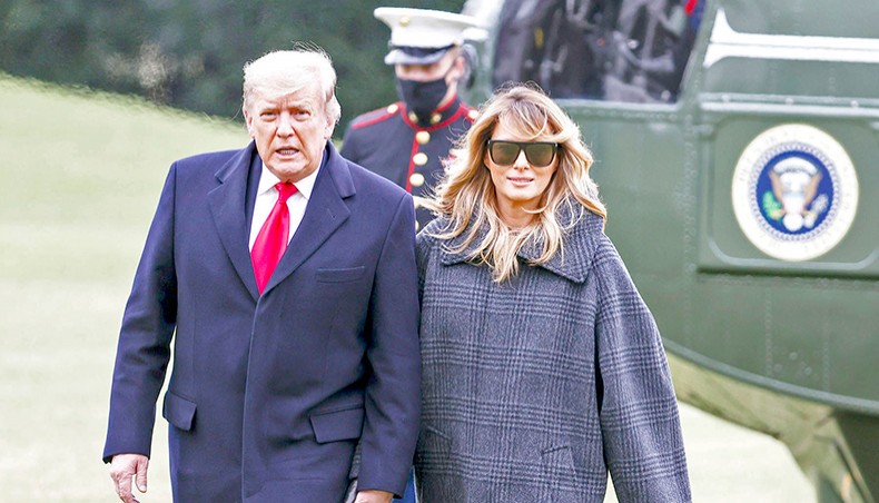 US president Donald Trump and First Lady Melania Trump depart Marine One on the South Lawn of the White House on December 31 in Washington, DC. — Agence France-Presse/Getty Images/Tasos Katopodis