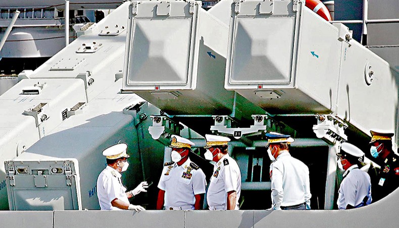 Myanmar’s commander-in-chief senior general Min Aung Hlaing, left, talks with military officers during the welcoming ceremony for new warships and a submarine to mark the Myanmar navy’s 73rd anniversary at the Irrawaddy Naval Region Command headquarters in Yangon on December 24, 2020. — Agence France-Presse/STR