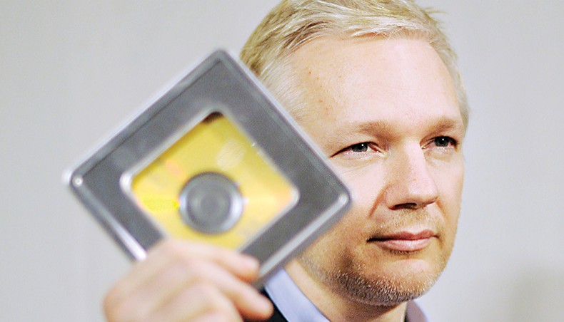 In this file photo taken on January 17, 2011 WikiLeaks founder Julian Assange holds a CD containing data given by former Swiss banker Rudolf Elmer following a press conference in London. — Agence France-Presse/Ben Stansall