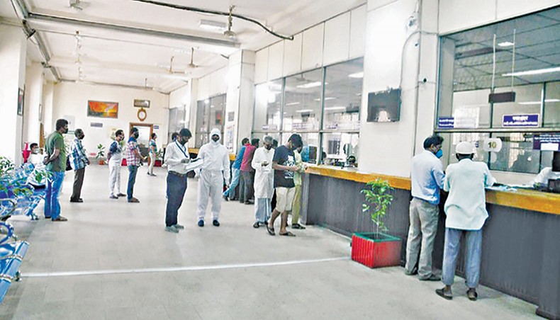 A file photo shows clients receiving services at a branch of a state-owned bank in the capital. — New Age photo