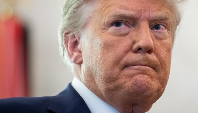 In this file photo taken on December 7, 2020 US President Donald Trump looks on during a ceremony presenting the Presidential Medal of Freedom to wrestler Dan Gable in the Oval Office of the White House in Washington, DC. - AFP photo