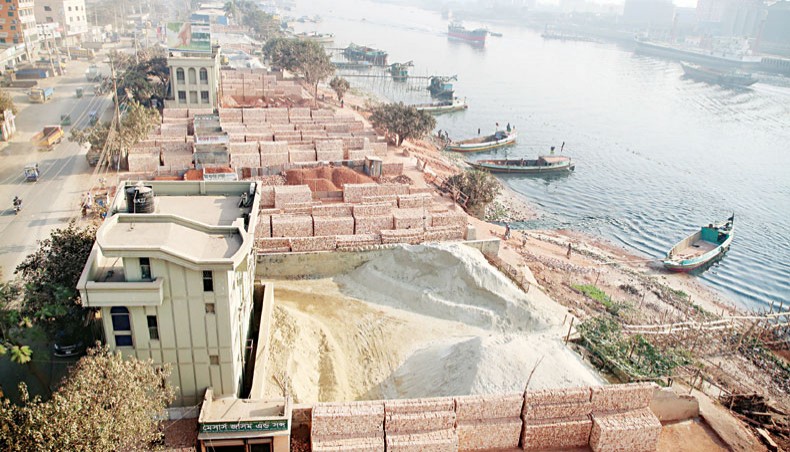 Construction material traders occupy Buriganga River land at Shyampur in Dhaka. This photo was taken on Friday. — Sony Ramany