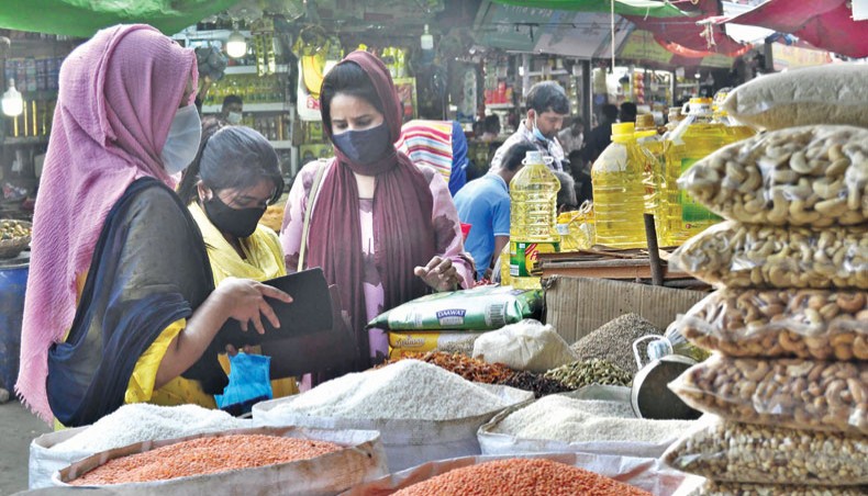 Customers buy rice at a shop at Karwan Bazar in the capital, Dhaka, on January 8. Experts on Sunday said that rice mill owners and wholesalers had raised prices of rice by taking advantage of low stock of food grains maintained by the government and its delayed decision to import the staple. — Focusbangla photo