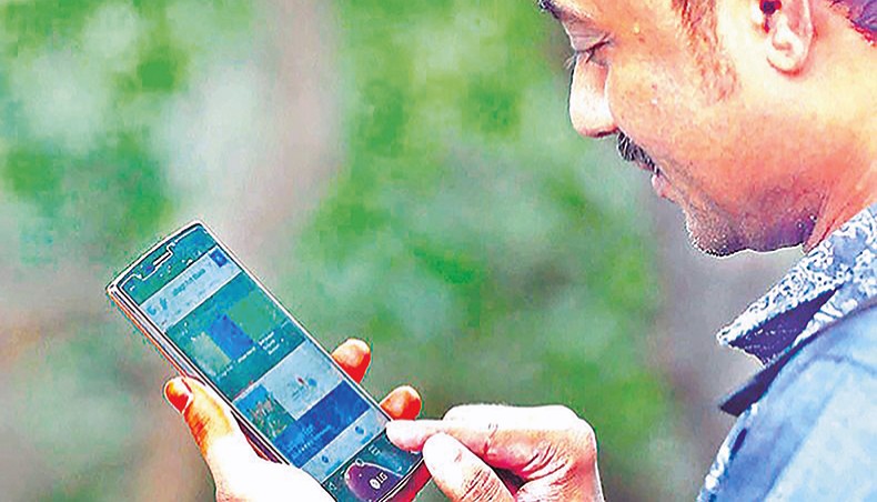 A file photo shows a man browsing internet on his mobile phone in Dhaka. The number of active mobile phone connections reached 17.01 crore in December 2020, according to Bangladesh Telecommunications Regulatory Commission data. — New Age photo