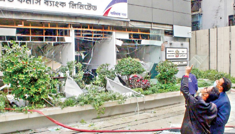 Bystanders look at the office of UAE visa centre at Gulshan in Dhaka on Wednesday afternoon after an air conditioner of the office exploded killing at least one person. — Sourav Lasker