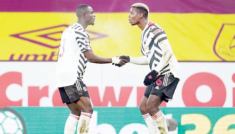Manchester United midfielder Paul Pogba (R) celebrates with team-mate Eric Bailly after scoring his team’s winning goal against Burnley during their Premier League match at Turf Moor on Tuesday. — AFP photo
