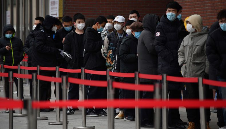 People line up outside a hospital to get COVID-19 tests in Beijing on January 14, 2021, on the same day China reported its first death from COVID-19 in eight months, as the country battles to contain a resurgence in cases and prepares for the arrival of an expert team from the WHO. — AFP photo