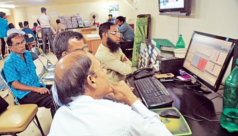 A file photo shows people monitoring share price movements on a computer screen at the Dhaka Stock Exchange in the capital. Dhaka stocks soared on Thursday as investors went for a buying binge after the Bangladesh Securities and Exchange Commission backtracked on its share price deviation probe move and set the upper ceiling on margin loan rate. — New Age photo