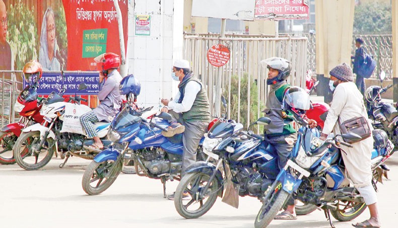 Freelance motorcyclists wait for passengers in front of Dhaka Railway Station at Kamalapur on Friday.— Sony Ramany
