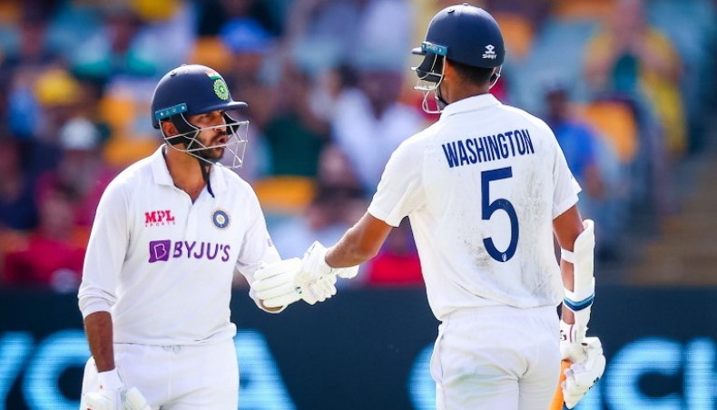 India's Washington Sundar (R) is congratulated by Shardul Thakur after reaching his half century on day three of their fourth Test against Australia at the Gabba in Brisbane on Sunday. — AFP photo