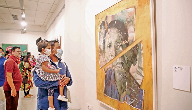 Visitors look at an artwork at the 22nd edition of Young Artists’ Art Exhibition at Bangladesh Shilpakala Academy. — Sony Ramany