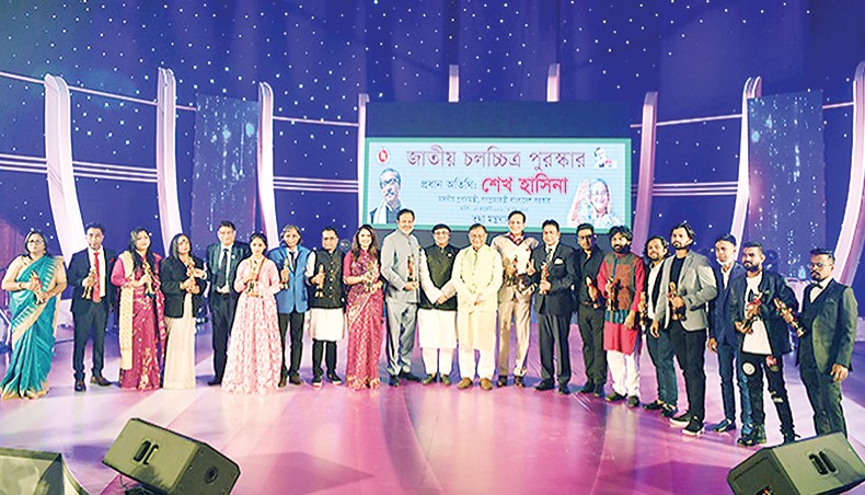 Information minister Hasan Mahmud together with the winners of National Film Award 2019 poses for a photo during the award ceremony at Bangabandhu International Conference Centre in Dhaka on Sunday. — BSS photo