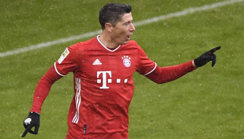 Bayern Munich forward Robert Lewandowski celebrates after scoring his team’s opening goal against SC Freiburg during their Bundesliga match in Munich on Sunday. — AFP photo