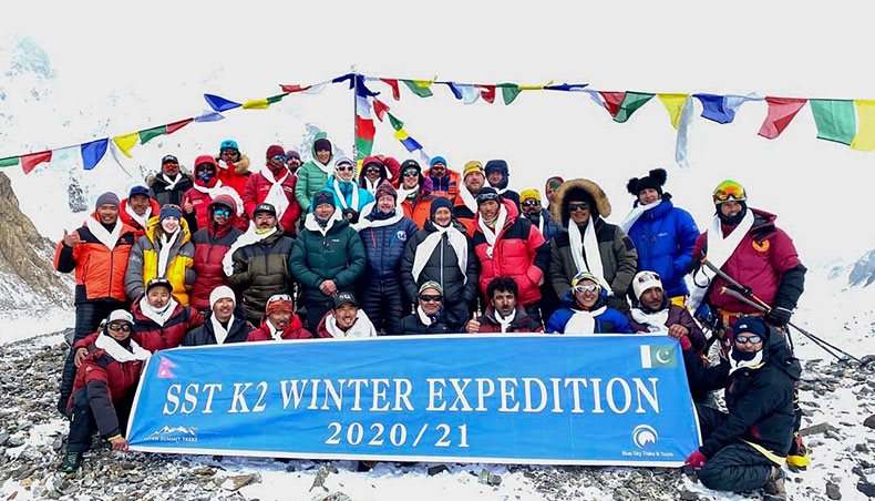 This hand-out photo taken on January 16, 2021 and released by Seven Summit Treks, shows mountaineers and Sherpas posing for pictures after reaching the summit of Mt K2, which is the second highest mountain in the world, at the Base Camp of the winter expedition in the Gilgit-Baltistan region of northern Pakistan. — AFP photo
