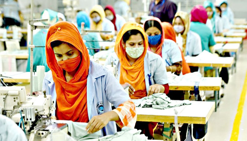 Women wearing face masks work at an apparel factory on the outskirts of Dhaka on January 3. — PA Images/Xinhua News Agency/Salim