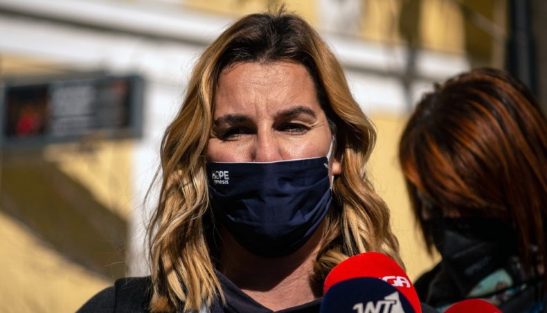 Greek Olympic sailing champion Sofia Bekatorou talks to journalists as she leaves the prosecutor's office after she testified on her sex abuse case in Athens on Wednesday. — AFP photo