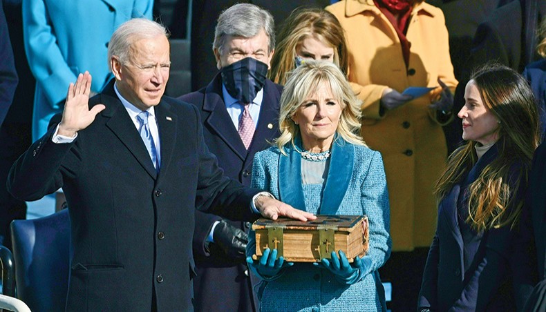Joe Biden, flanked by incoming US first lady Jill Biden, takes the oath of office during the swearing-in ceremony of the 46th US president on Wednesday, at the US Capitol in Washington, DC. — AFP photo