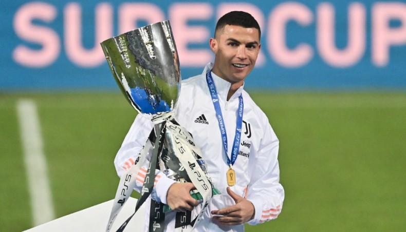 Juventus forward Cristiano Ronaldo poses with the Italian Super Cup trophy after defeating Napoli in the final at the Mapei stadium in Reggio on Wednesday. — AFP photo