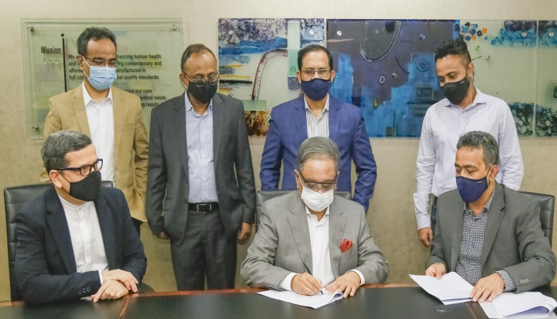 Beximco Pharmaceuticals Limited managing director Nazmul Hasan, center, signs an agreement as the company on Thursday announced to buy 54.6 per cent shares of the Bangladesh unit of French pharmaceutical giant Sanofi. — New Age photo