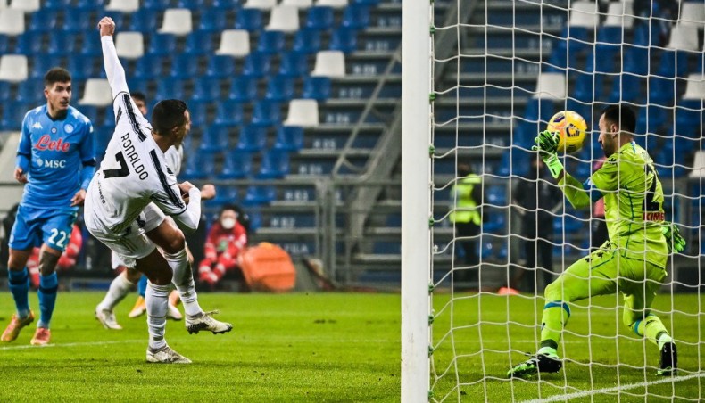 Juventus forward Cristiano Ronaldo (L) shoots to score past Napoli goalkeeper David Ospina during their Italian Super Cup final at the Mapei stadium in Reggio Emilia on Wednesday. — AFP photo