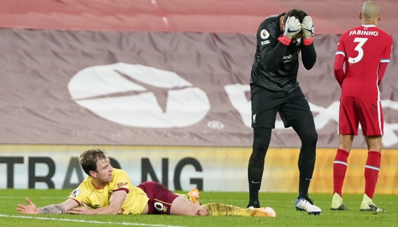 Liverpool goalkeeper Alisson Becker (R) reacts after fouling Burnley striker Ashley Barnes (L) to concede a penalty during their Premier League match at Anfield on Thursday.— AFP photo