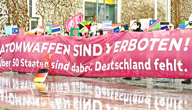 Anti-nuclear activists of International Campaign to Abolish Nuclear Weapons and other peace initiatives stage a protest with 51 flags of countries that ratified the UN Treaty to Ban Nuclear Weapons and a nabber reading ‘Nuclear weapons are forbidden ! More than 50 states joined. Germany didn’t’, in front of the Chancellery in Berlin, on Friday. The UN Treaty on the Prohibition of Nuclear Weapons comes into force on Friday. — AFP photo