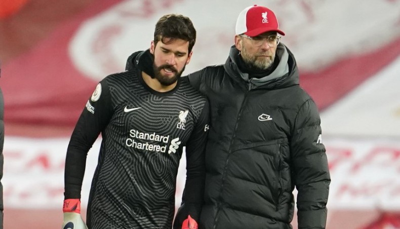 Liverpool manager Jurgen Klopp (R) reacts with goalkeeper Alisson Becker at the end of their Premier League match against Burnley at Anfield on Thursday. — AFP photo