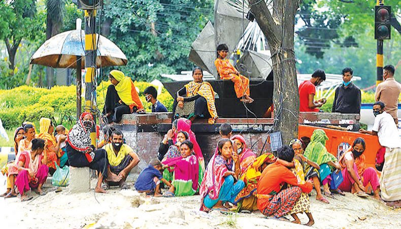A file photo shows relief-seekers waiting on a street island near the National Press Club in Dhaka as the COVID-19 outbreak pushed the poor to streets to receive food from donors. The rate of poverty in the country has surged due to the COVID-19 outbreak, according to a survey conducted by the South Asian Network on Economic Modeling. — New Age photo