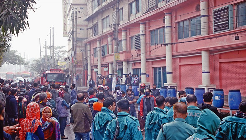 People gather around Oli Garments factory building at Kamalapur in Dhaka on Sunday after a fire broke out on the fifth floor of the building. — New Age photo