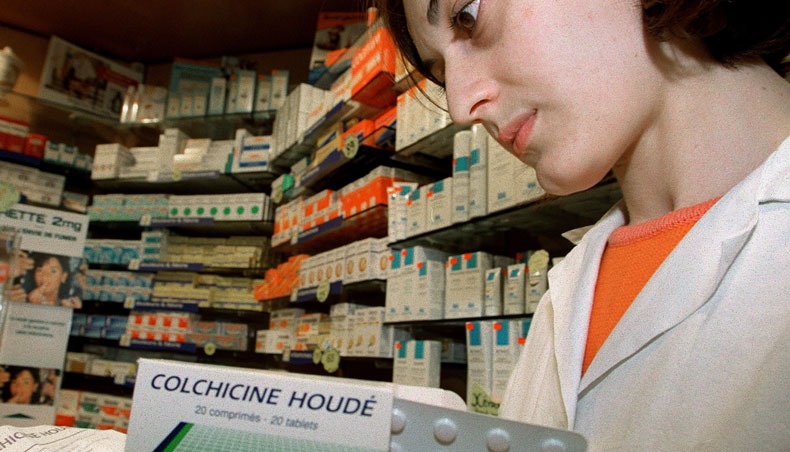 In this file photo taken on September 16, 1998 a pharmacist presents the drug Colchicine, which is a therapeutic trial against cystic fibrosis launched in France, according to Professor Gérard Lenoir, paediatrics, Necker hospital, Paris. — AFP photo