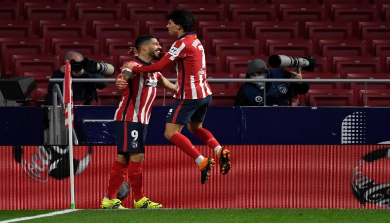 Atletico Madrid forward Luis Suarez (L) celebrates his goal with team-mate Joao Felix during their La Liga match against Valencia at the Wanda Metropolitano stadium in Madrid on Sunday. — AFP photo
