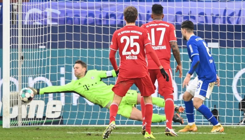 Bayern Munich goalkeeper Manuel Neuer (L) makes a save during their Bundesliga match against Schalke 04 in Gelsenkirchen on Sunday. — AFP photo