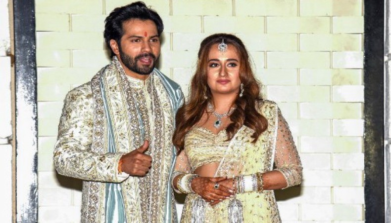 In this picture taken on January 24, 2021, Bollywood actor Varun Dhawan and fashion designer Natasha Dalal pose after their wedding in Alibag.- AFP photo