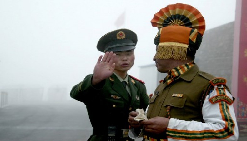 In this file photo taken on July 10, 2008 a Chinese soldier gestures as he stands near an Indian soldier on the Chinese side of the ancient Nathu La border crossing between India and China.- AFP photo