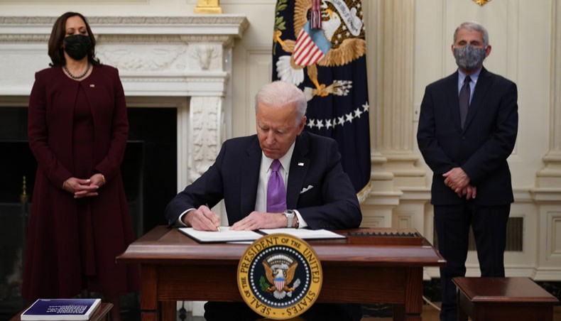 US president Joe Biden signs executive orders in the State Dining Room of the White House in Washington, DC on January 21. — AFP Photo