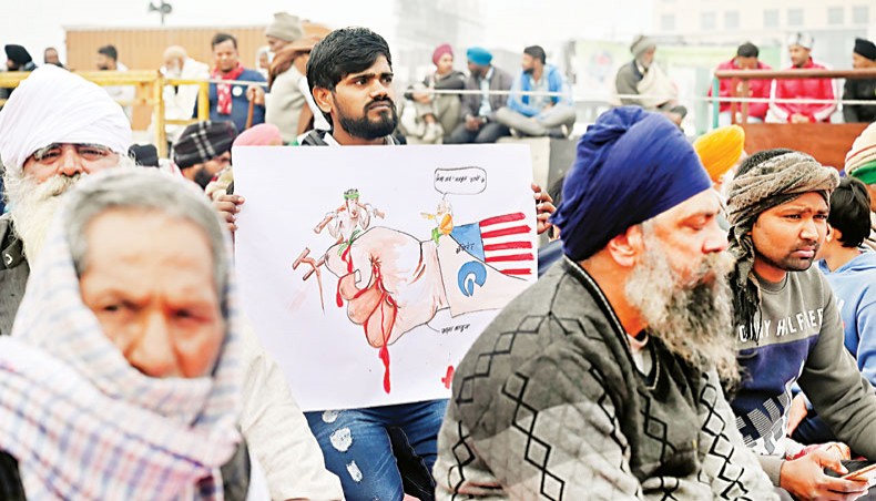 Farmers sit along a blocked highway as they continue to protest against India’s recent agricultural reforms at the Delhi-Uttar Pradesh state border in Ghazipur on January 18. — Agence France-Presse/Sajjad Hussain