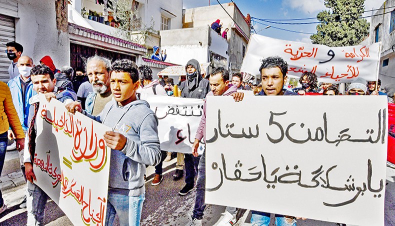 Protesters from the Ettadhamen city suburb on the northwestwern outskirts of Tunisia’s capital Tunis march on Tuesday in a bid to pass onwards to reach an anti-government demonstration outside the Tunisian Assembly headquarters. — AFP photo
