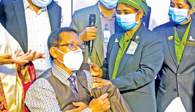 A health worker administers coronavirus vaccine on a person at Kurmitola General Hospital in Dhaka on the first day of vaccination programme on Wednesday. — Sourav Lasker