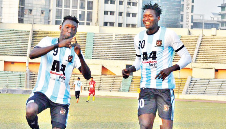 Sheikh Jamal Dhanmondi Club’s Gambian forward Pa Omar Jobe (L) celebrates after scoring one of his four goals against Arambagh Krira Sangha during their Bangladesh Premier League at the BNS on Wednesday. — BFF photo