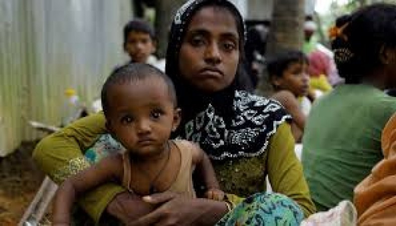 A Rohingya woman and her child pose for a photo at a Rohingya camp in Bangladesh. -- New Age file photo