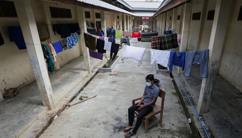 This picture taken on January 30, 2021 shows a Rohingya refugee sitting at the makeshift camp in Lhokseumawe, Aceh province, where only just over 100 refugees remain well down from the almost 400 who arrived in separate boat landings between June and September 2020. -- AFP photo