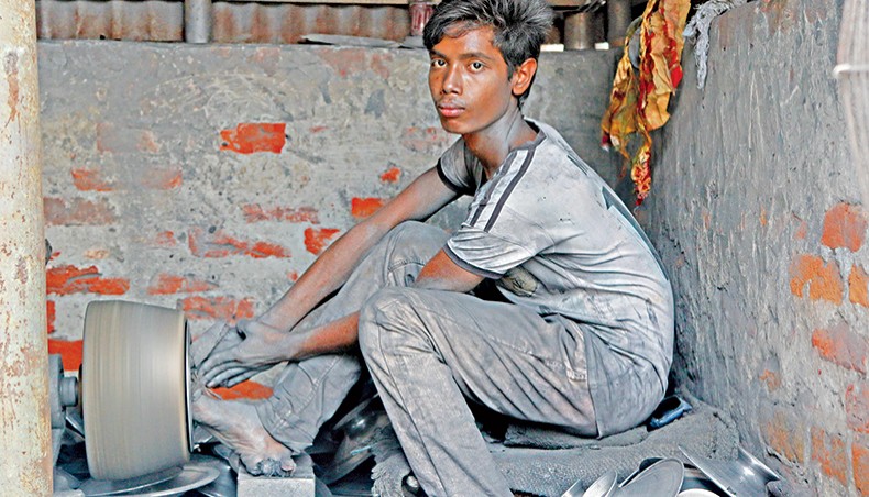 A file photo shows an underage worker performing a hazardous task at a factory in the capital. The government is considering ratification of the International Labour Organisation’s minimum age convention for admission into employment in a bid to keep its duty-free market access to the European market intact. — New Age photo