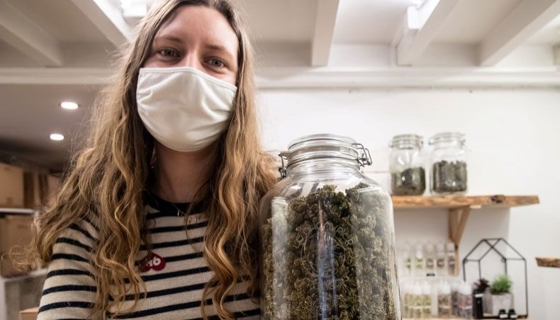 Shop teller Julie T'ioen poses with a jar of hemp flower inside 'Le Chanvrier Francais' CBD shop in Paris on February 2, 2021. -- AFP photo
