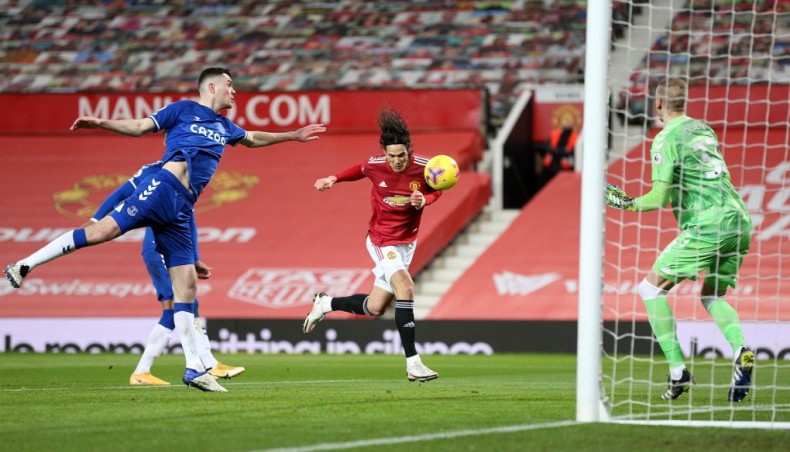 Manchester United striker Edinson Cavani (C) heads to score his team's first goal during their Premier League match against Everton at Old Trafford on Saturday.— AFP photo
