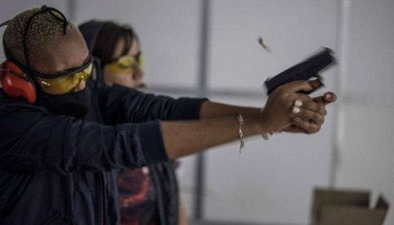 A spent shell leaves from a pistol fired by a South African woman as she takes part in a training organised by the women empowerment group Girls on Fire, in Midrand, on February 7, 2021. — AFP photo