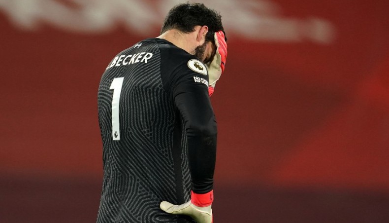 Liverpool goalkeeper Alisson Becker reacts after conceding their third goal against Manchester City during their Premier League match at Anfield on Sunday. — AFP photo