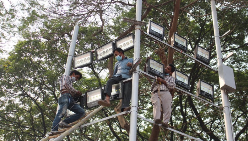 Workers set up lights near Central Shaheed Minar on Thursday ahead of International Mother Language Day.- Focus Bangla photo
