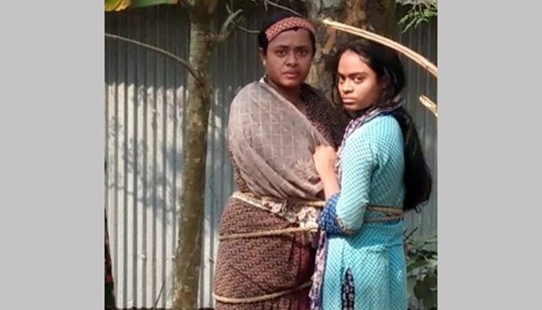 A woman and her daughter are tied to a tree at Kaliakoir in Gazipur on Thursday as they failed to pay back loans. — New Age photo