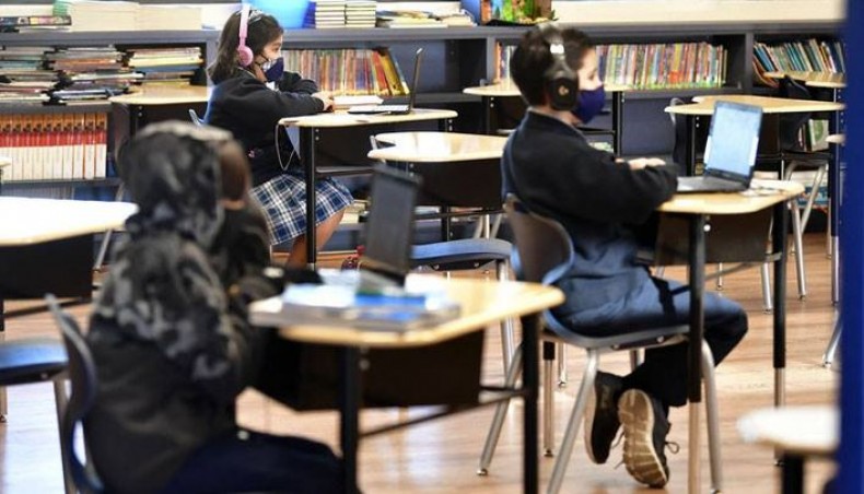 In this file photo taken on November 16, 2020 students sit with their laptop computers at St Joseph Catholic School in La Puente, California where pre-kindergarten to second grade students in need of special services returned to the classroom today for in-person instruction. -- AFP photo