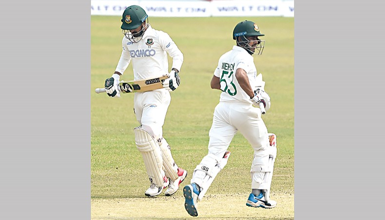 Bangladesh batsmen Liton Das (L) and Mehidy Hasan run between the wickets on the third day of their second Test against West Indies at the Sher-e-Bangla National Stadium on Saturday. — AFP photo